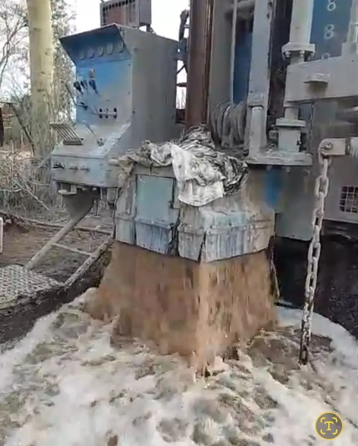 Water and drill cuttings flowing from a borehole during drilling in Kenya