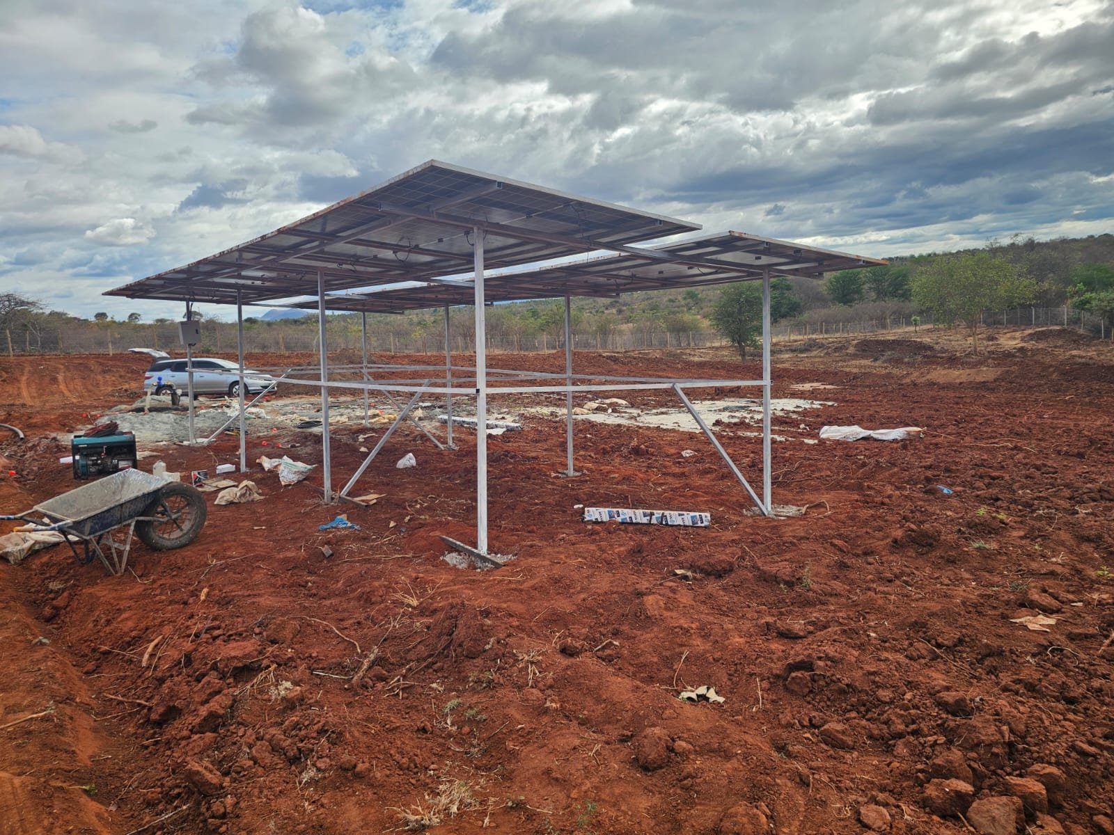 Hydrogeologist taking resistivity readings to locate groundwater on a plot in Kenya