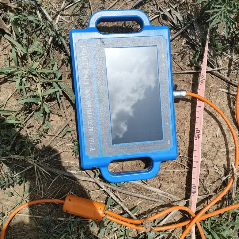 Geophysical survey instrument connected to a measuring line on a farm in Kenya